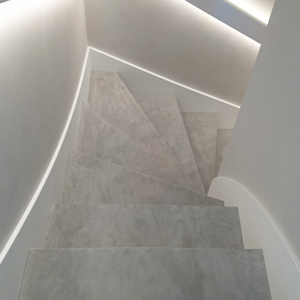 Stairs clad in light gray suede leather.
