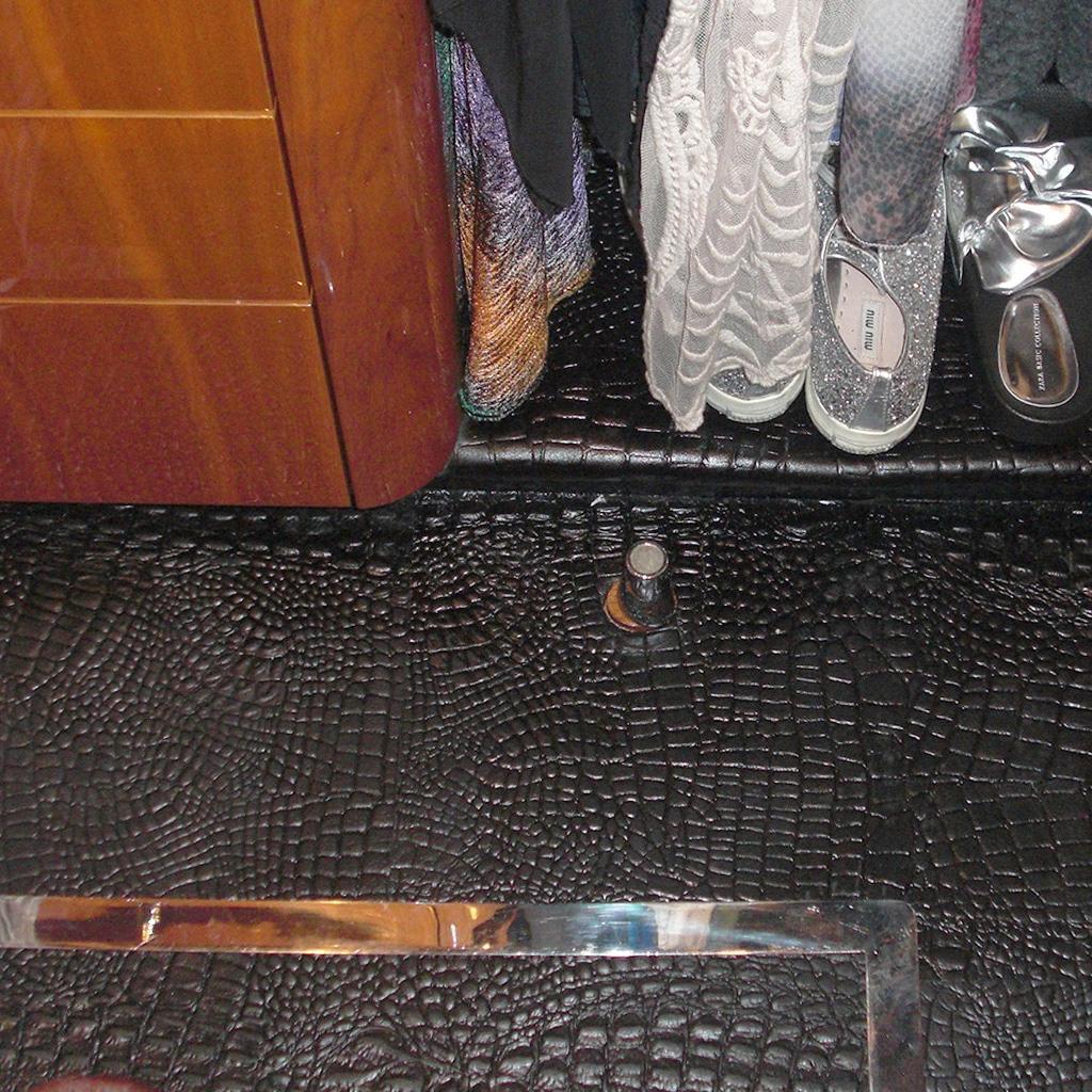 Black caiman-embossed leather flooring on board a yacht.