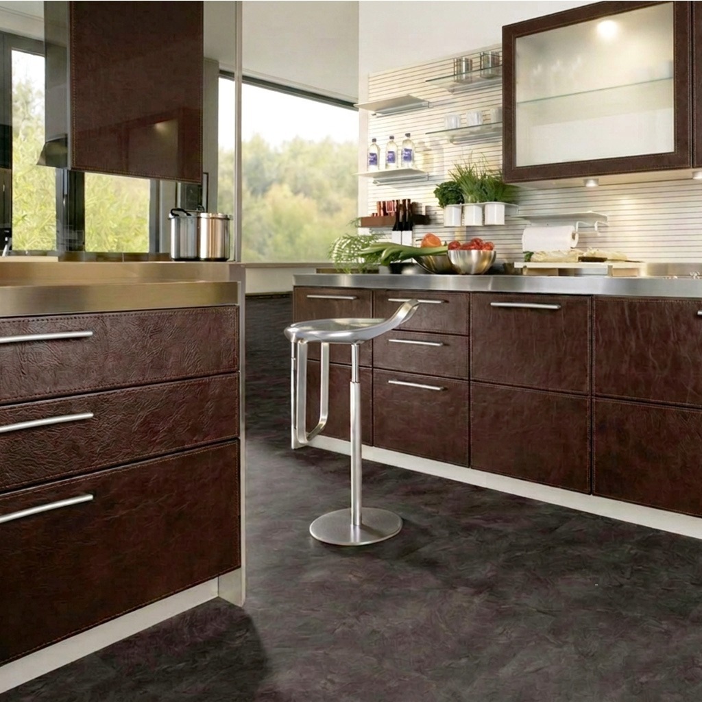 Kitchen with cabinet fronts clad in textured brown leather.