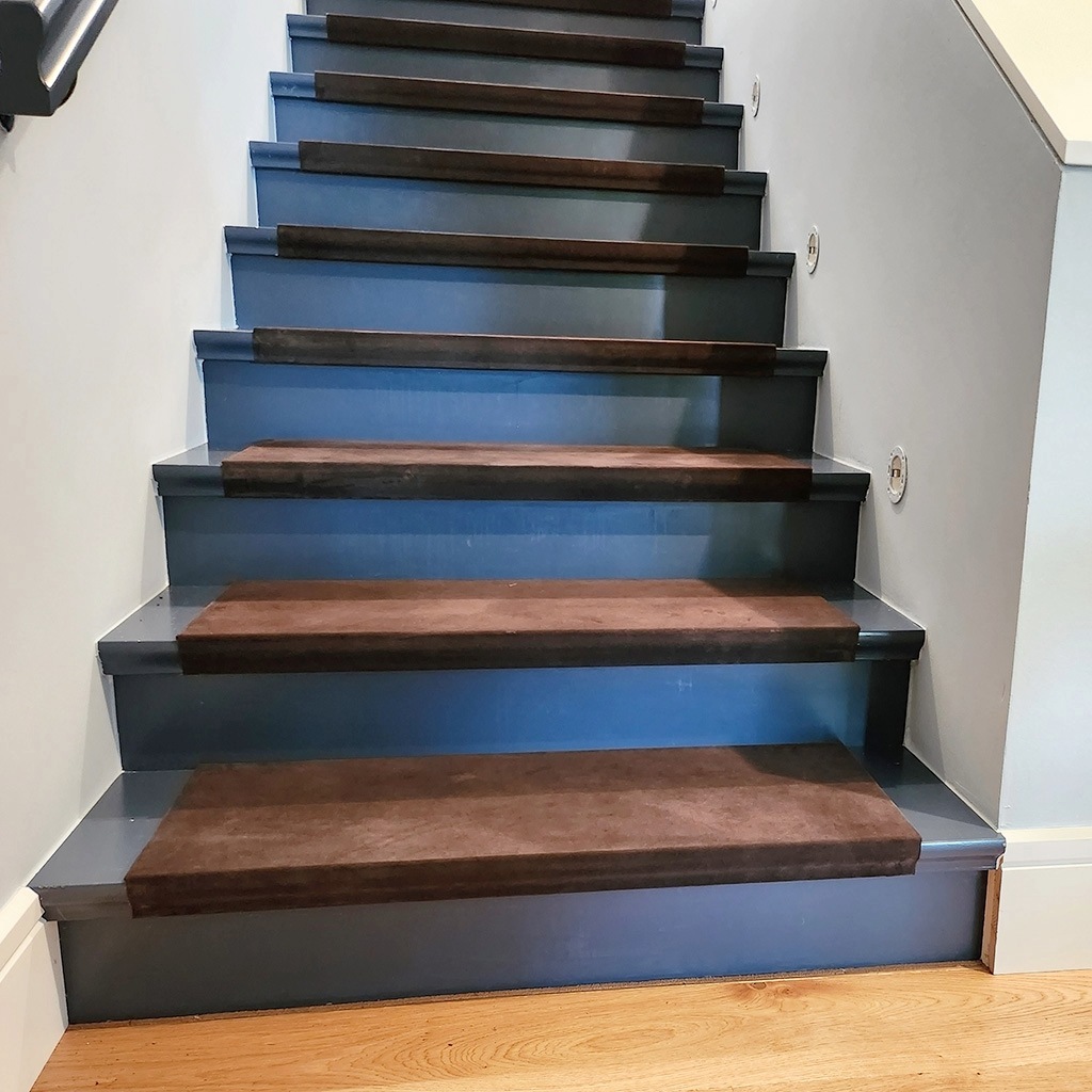 Brown suede leather tread covers on a staircase.