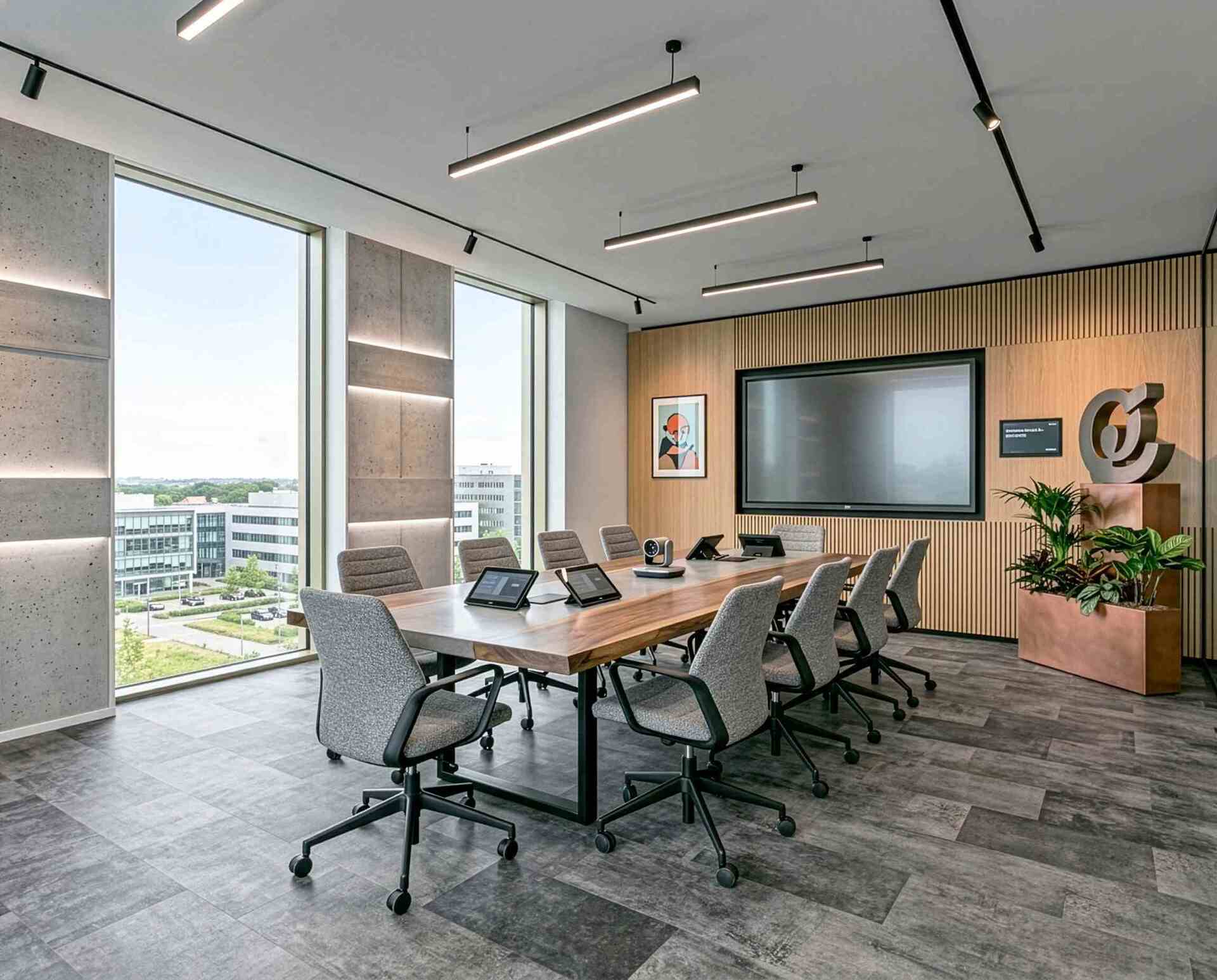 Meeting room with gray leather flooring and a large window.